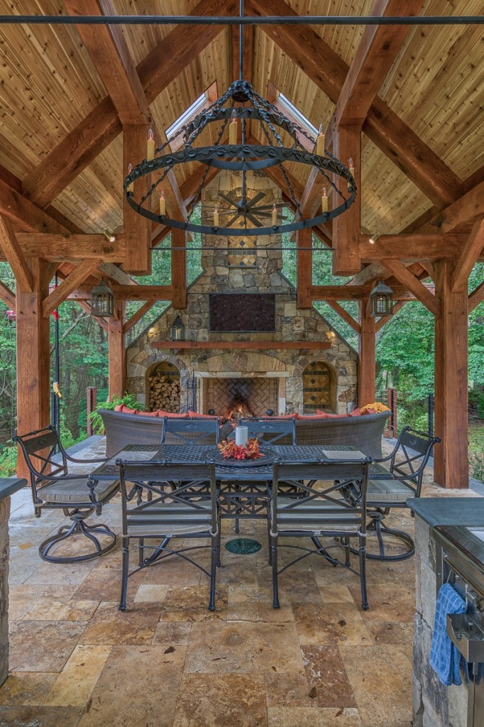 timber frame outdoor entertaining pavilion with stone fireplace