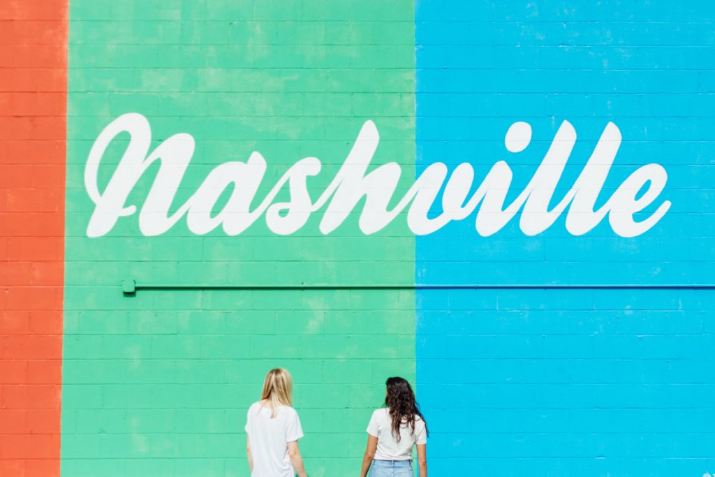 Two women standing in front of Nashville mural